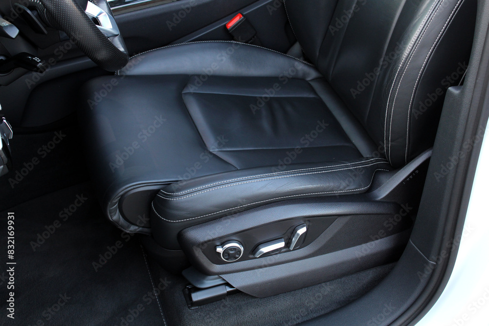 Driver seat of a new modern car. Leather car interior. Black leather drivers seat in a car. Front seats of a modern passenger car. Driver seat of a new modern car. Leather car interior. Black leather drivers seat in a car. Front seats of a modern passenger car.