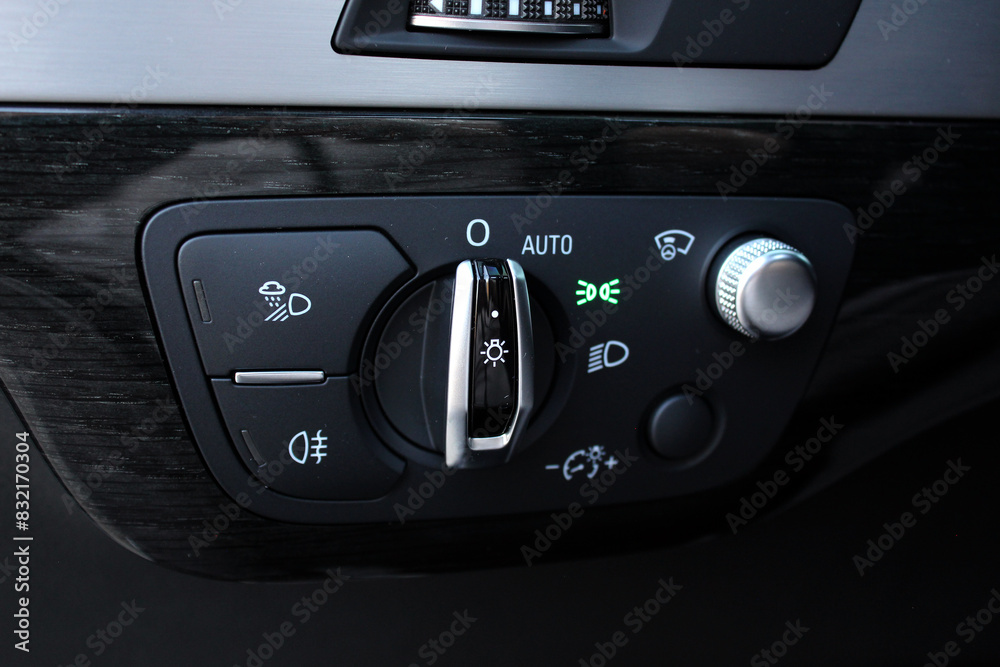 Light control panel in a lux car. Car light switch. Dashboard for switching on the headlights and fog lights. 