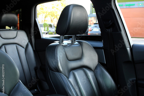 Premium driver's seat. Close-up black headrest drivers seat made of genuine leather. Driver seat of a new luxury vehicle. Lux Leather car interior. Black leather car seats in the expensive car. © Best Auto Photo