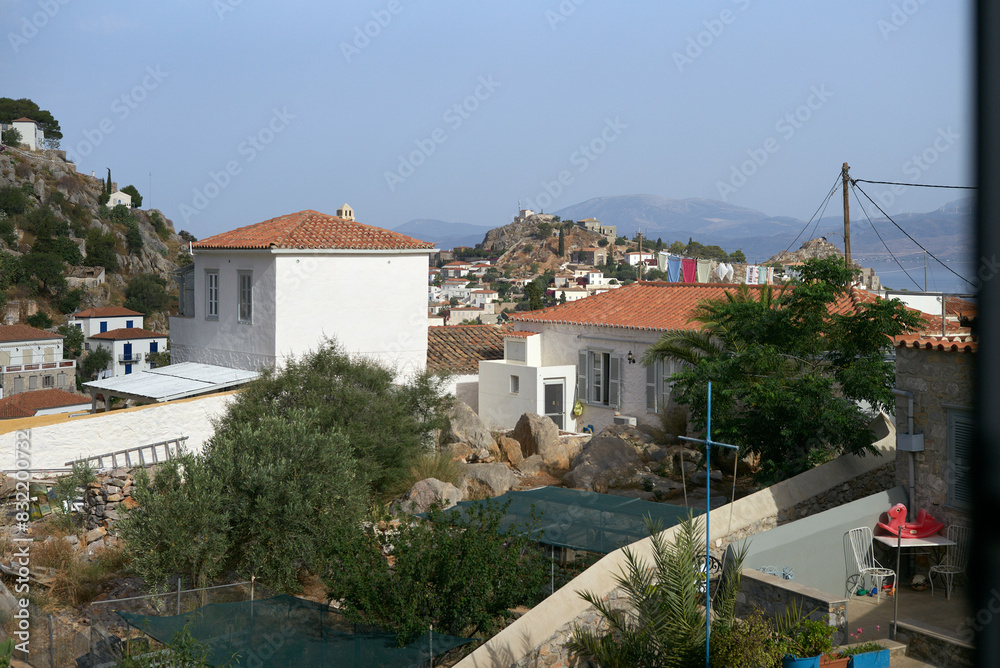 This is a scenic view of a Mediterranean coastal town with white buildings, terracotta roofs, and a hilltop castle in the distance, under a clear blue sky. This is a scenic view of a Mediterranean coastal town with white buildings, terracotta roofs, and a hilltop castle in the distance, under a clear blue sky.