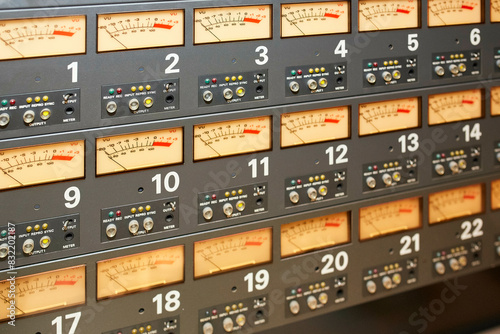 A close-up of an industrial control panel with numbered gauges, dials, and indicator lights.