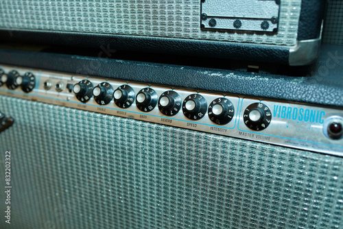 A close-up view of a vintage Vibrosonic guitar amplifier showcasing its control knobs and textured grille.