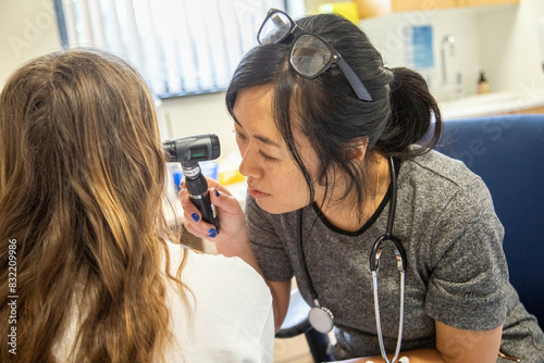 Doctor performing an ear examination on a patient