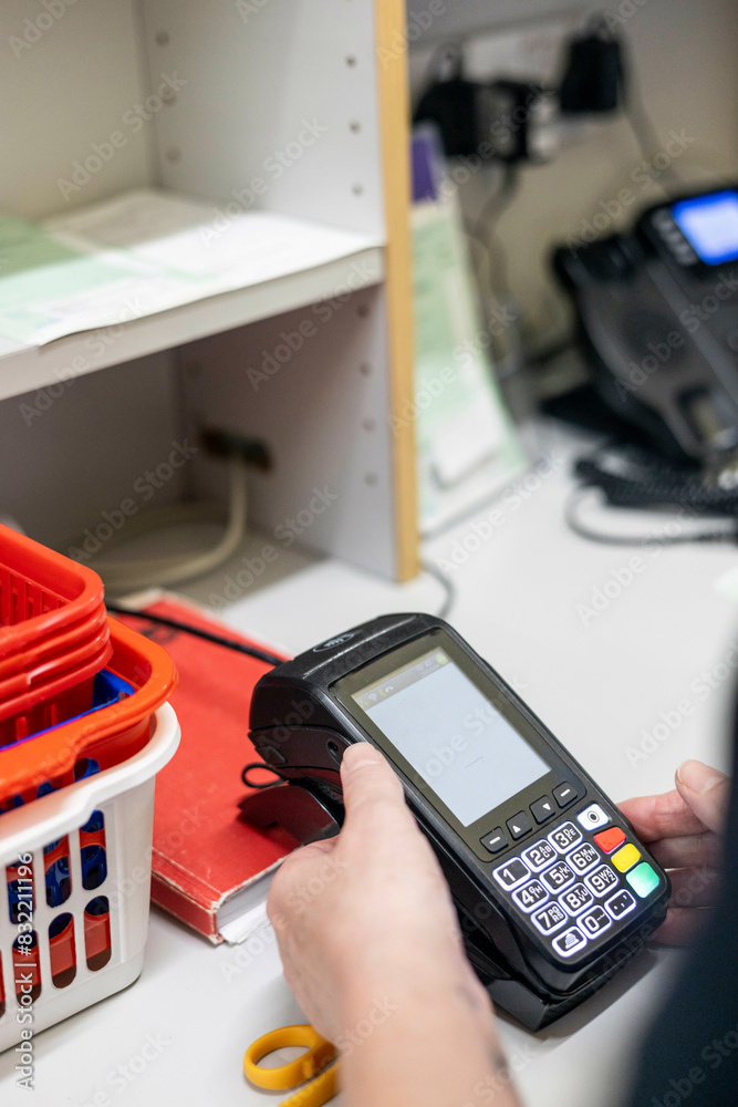 Hand using a handheld scanner in a workspace of a medical practice Hand using a handheld scanner in a workspace of a medical practice
