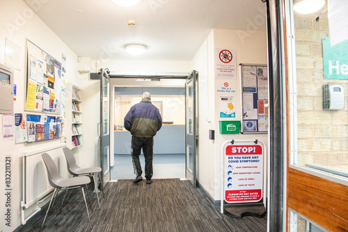 Person exiting through the doorway of a clinic. photo