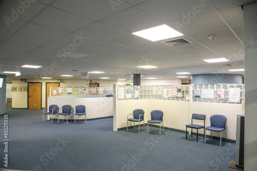 Empty Spacious waiting area with chairs and bulletin boards in a medical practise photo