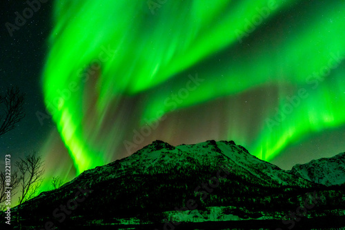 Polar lights, Aurora borealis in green over mountains, Norway. Shaped like a heart