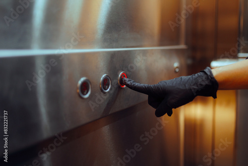 Germophobic Person Puts on Gloves to Touch the Elevator Buttons. Irrational fear of germs and viruses especially manifested in public spaces 
 photo