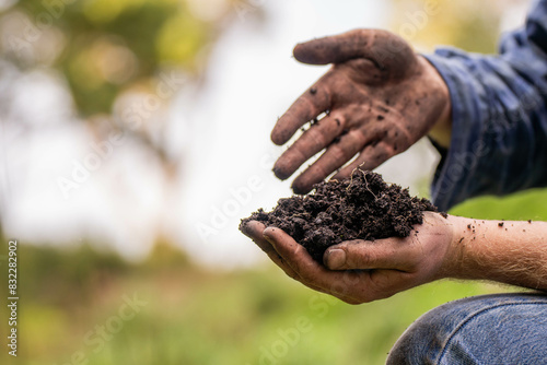 farmer holding soil looking at soil carbon in the america