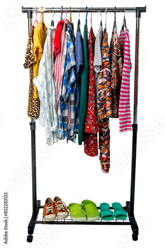Different clothes and shoes from the wardrobe on the rack