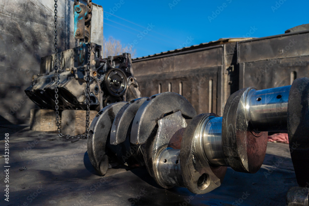 Closeup of a soviet truck engine crankshaft laid on truck bed.