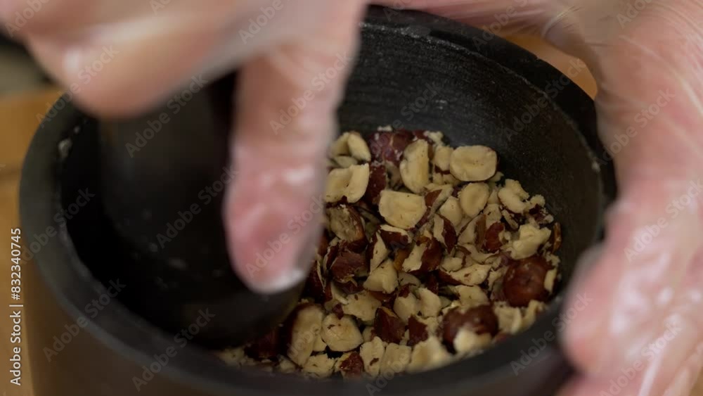 Grinding almonds in a stone kernel Grinding almonds in a stone kernel