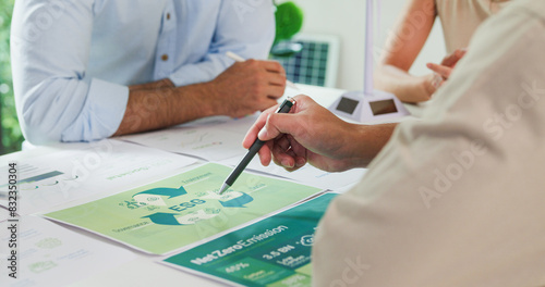 Closeup group Asia businesspeople talk ESG strategies risk management workshop, SDGs report, global warming, green finance investment eco friendly and net zero waste in boardroom training building.