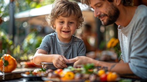 Father with little son grilling outside during family summer garden party