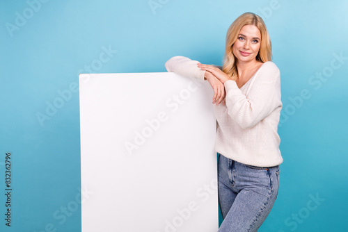 Photo of pretty nice adorable woman wear stylish white clothes empty space isolated on blue color background
