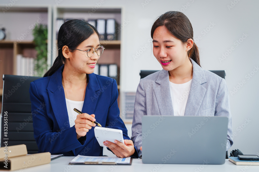 Two Asian businesswomen collaborate on stock market strategies and financial services, exchanging comments and suggestions on loan applications and investment opportunities. Two Asian businesswomen collaborate on stock market strategies and financial services, exchanging comments and suggestions on loan applications and investment opportunities.