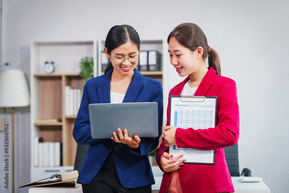 Two Asian businesswomen collaborate on stock market strategies and financial services, exchanging comments and suggestions on loan applications and investment opportunities. Two Asian businesswomen collaborate on stock market strategies and financial services, exchanging comments and suggestions on loan applications and investment opportunities.
