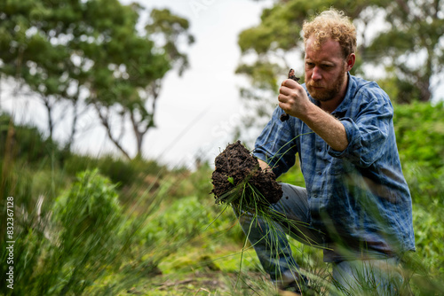 farmer holding soil taking a soil sample for a soil test in a field. Testing carbon sequestration and plant health in Australia photo