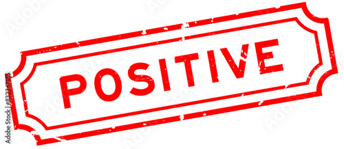 Grunge red positive word rubber seal stamp on white background