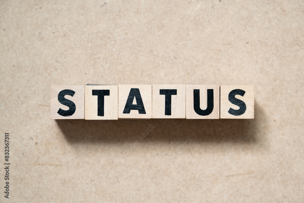 Alphabet letter block in word status on wood background Alphabet letter block in word status on wood background