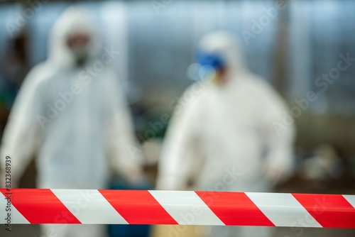 Man inspector scientist investigate chemical gas leak spill with safety face mask PPE suit in area closed barricade security red white tape. danger area infected toxic leak spill cross stripe ribbon photo