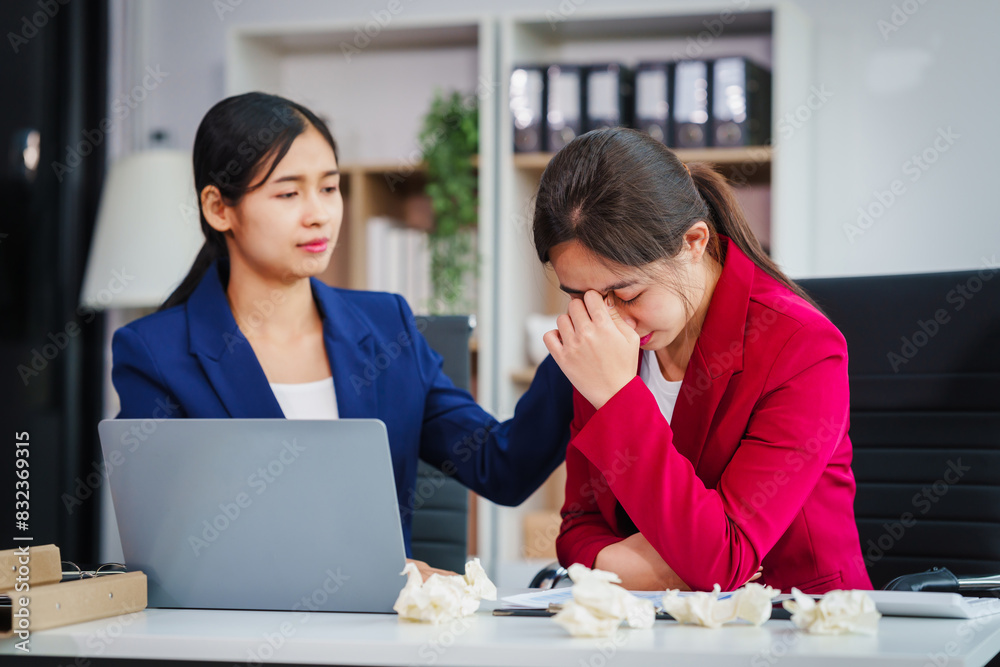 Two Asian businesswomen under stress and pressure discuss financial matters, experiencing anxiety and worry while navigating the complexities of the stock market and loan applications. Two Asian businesswomen under stress and pressure discuss financial matters, experiencing anxiety and worry while navigating the complexities of the stock market and loan applications.