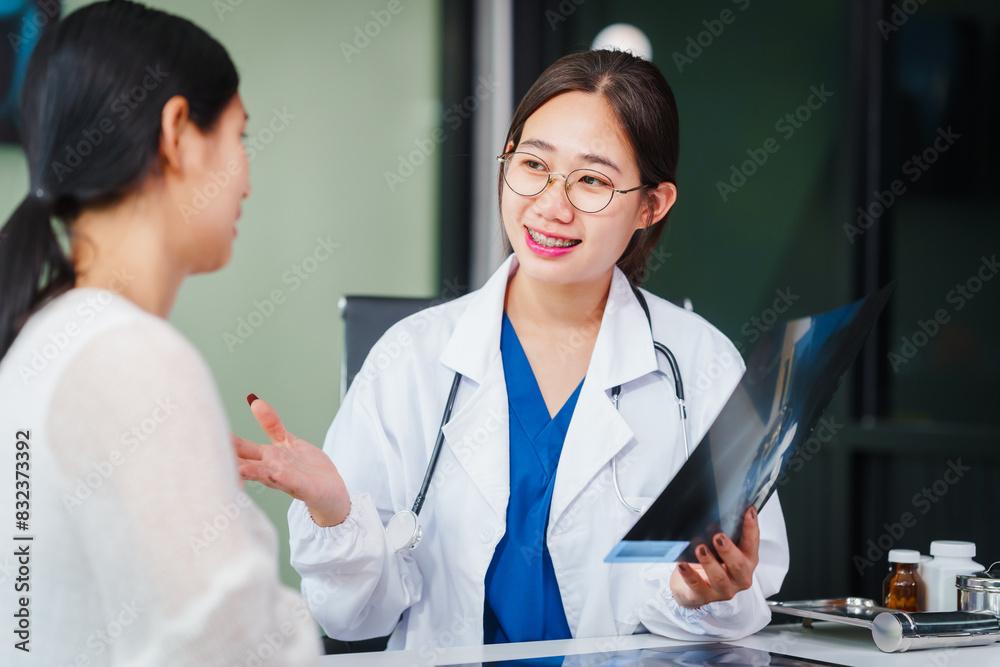 Asian female doctor specializing in psychiatry works at her desk, providing psychotherapy, diagnosis, treatment, and counseling to psychiatric patients, utilizing x-ray films for assessments. Asian female doctor specializing in psychiatry works at her desk, providing psychotherapy, diagnosis, treatment, and counseling to psychiatric patients, utilizing x-ray films for assessments.