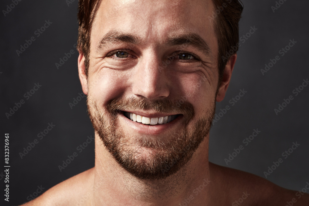 Fototapeta premium Man, portrait and shine of skincare in studio, confidence and beauty on black background, Male person, happy and cosmetics for facial treatment or clean and smooth skin, dermatology and proud health