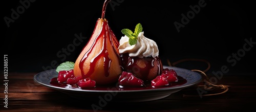 Plate of tasty poached pears in wine sauce on dark background. copy space available photo