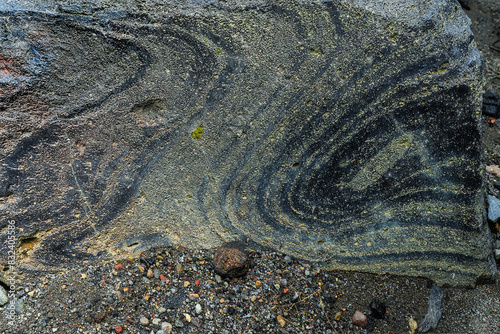 Swirly flow lines of volcanic glass (obsidian) within a piece of lava at Mount Lokon volcano near Tomohon city, Gunung Lokon, Tomohon, North Sulawesi, Indonesia