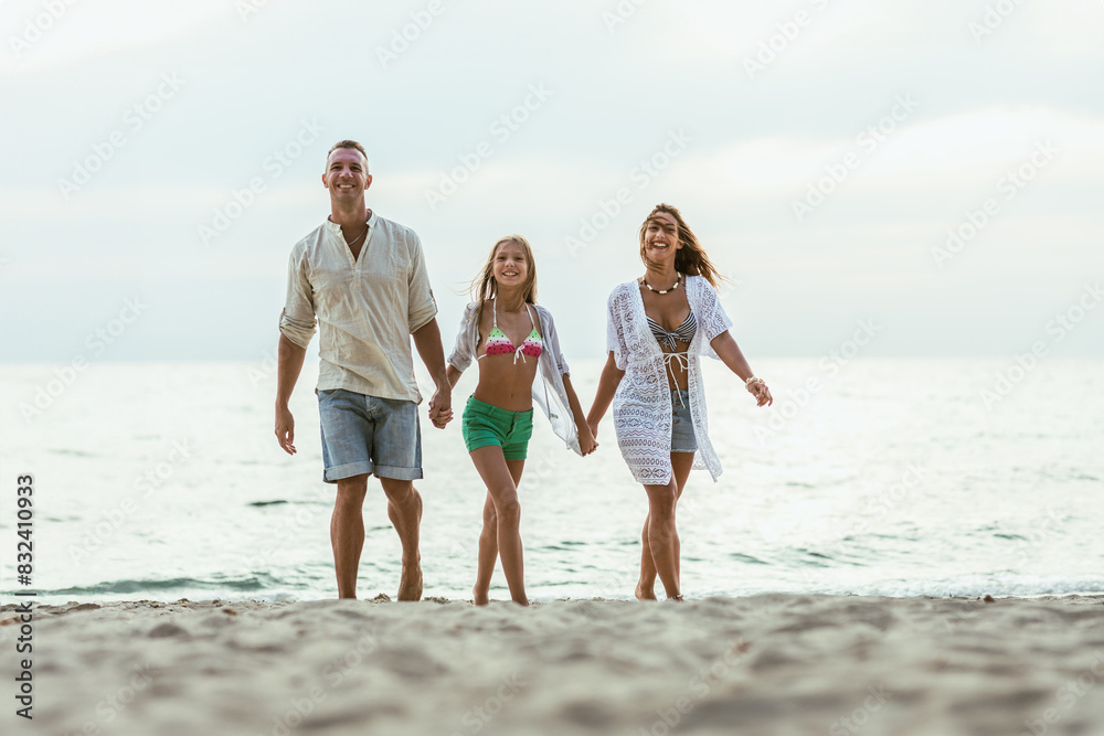 Family Walking on Beach Holding Hands Family Walking on Beach Holding Hands