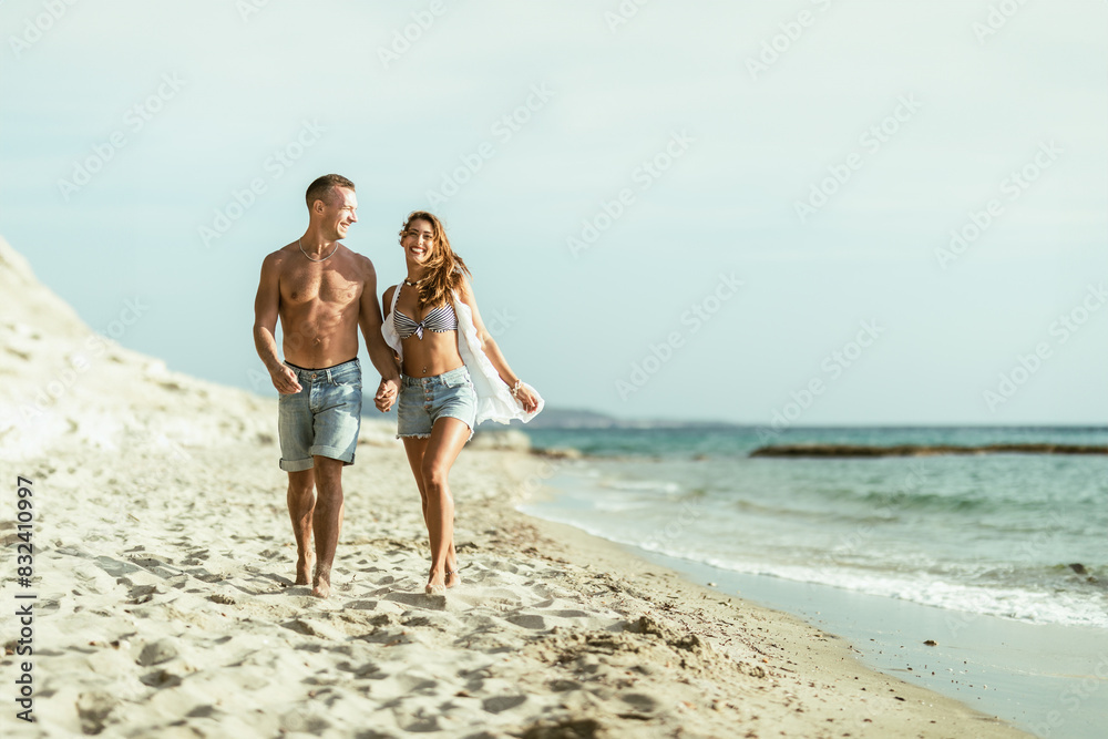 Man and Woman Walking on the Beach