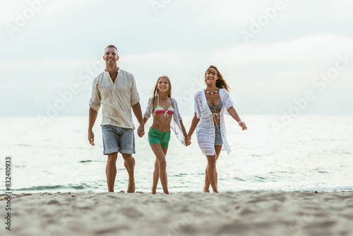 Family Walking on Beach Holding Hands