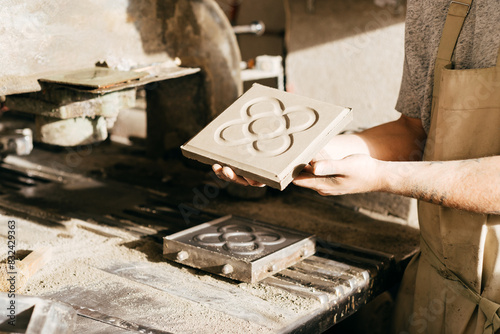 Photography Close-up of Craftsman Displaying Cement Tile With Barcelona Panot Design in Work