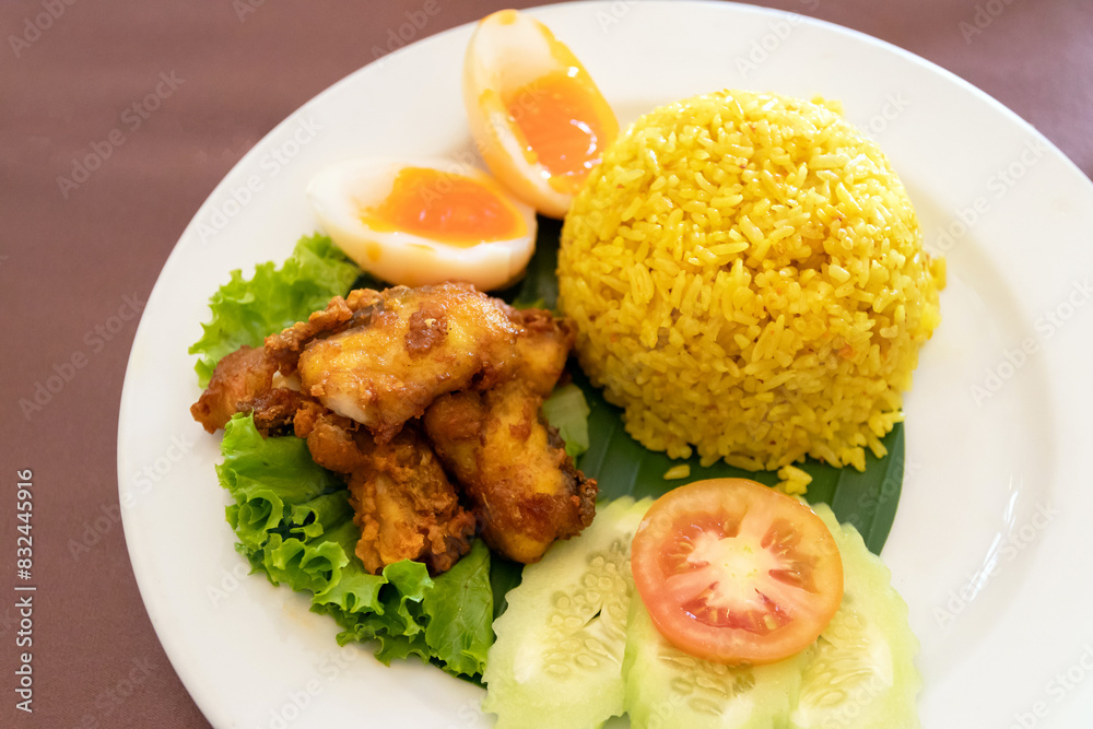 Chicken rice curry with coconut milk ( Koa Mook Gai). The dish features tender chicken, fluffy rice, and a variety of fresh vegetables. Chicken rice curry with coconut milk ( Koa Mook Gai). The dish features tender chicken, fluffy rice, and a variety of fresh vegetables.