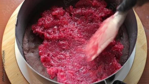 Cherry pie. Process. The confectioner lays out cherry puree for making a cake
