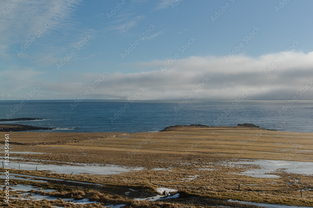 Coastal view with a clear blue sky and calm ocean Iceland no people outside Coastal view with a clear blue sky and calm ocean Iceland no people outside