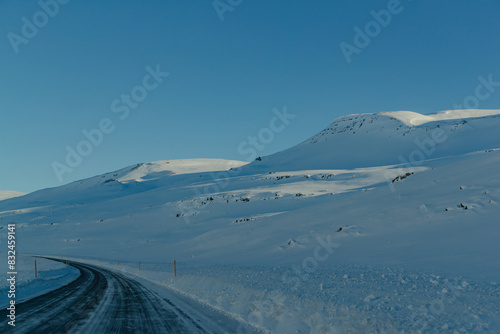 Snow-covered road through remote, snowy landscape © JUNHYEOK CHOI