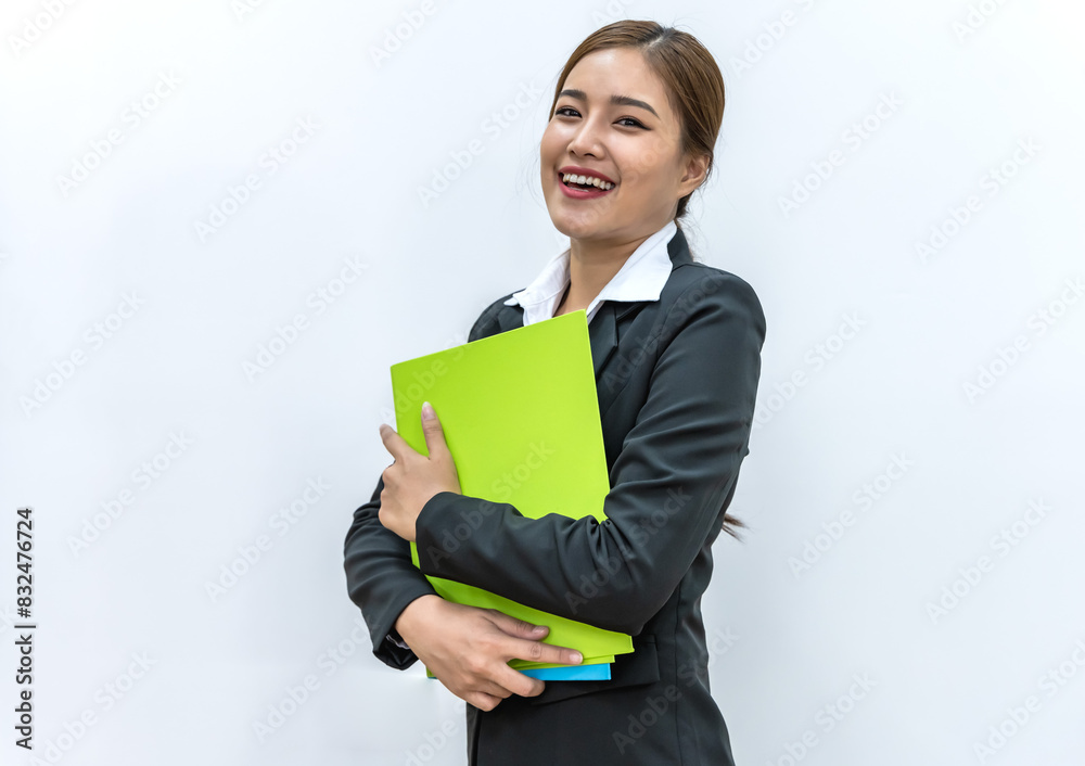 Smiling young Asian woman in casual black suit holding file on white background Smiling young Asian woman in casual black suit holding file on white background