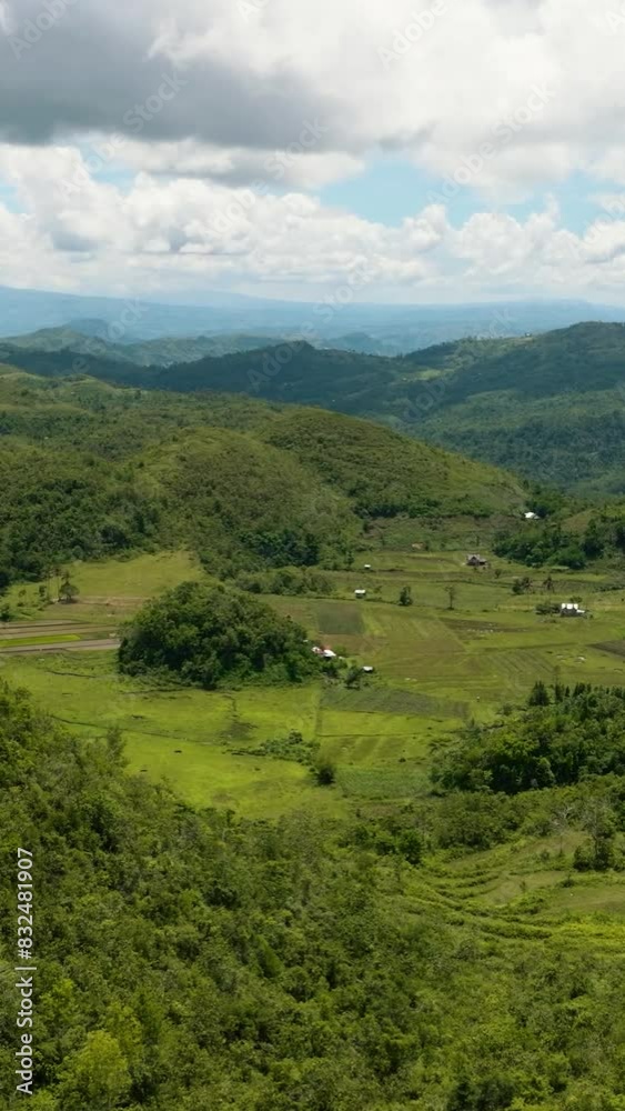 Aerial drone of conical hills with green vegetation in a mountainous area. Hinakpan Chocolate Hills. Negros, Philippines
