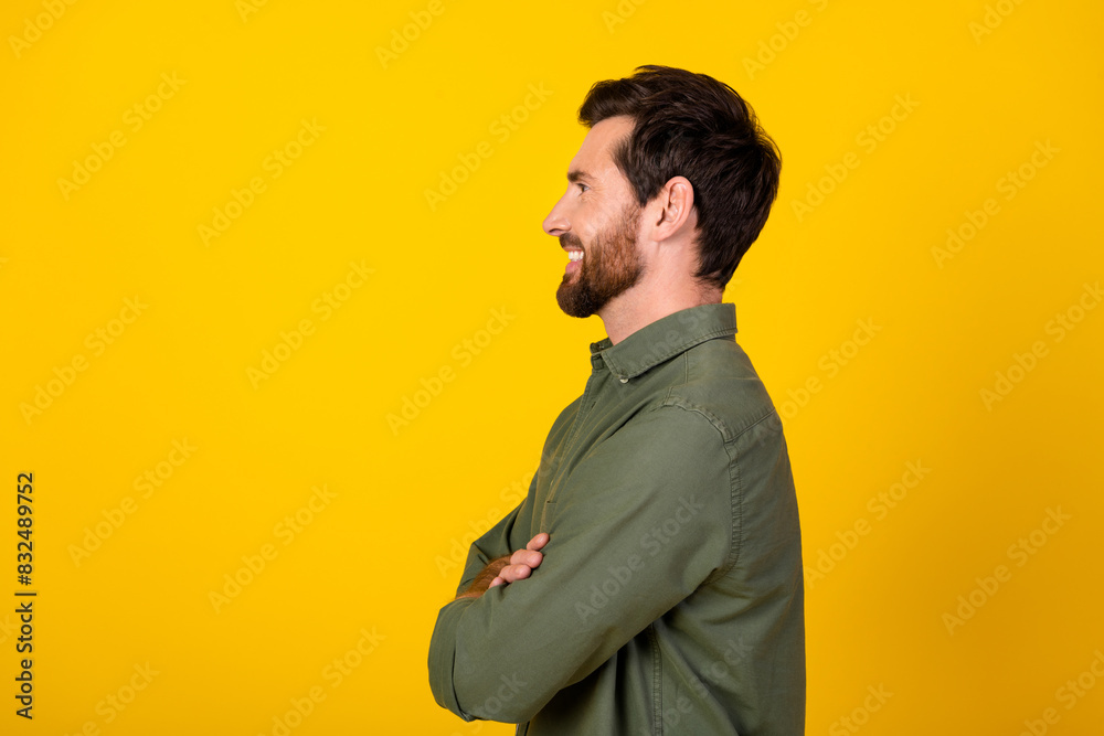 Photo of nice young man folded hands empty space wear shirt isolated on yellow color background Photo of nice young man folded hands empty space wear shirt isolated on yellow color background