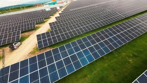 FPV drone video flying over a large solar panel field, showcasing renewable energy and sustainable technology in a vast landscape.