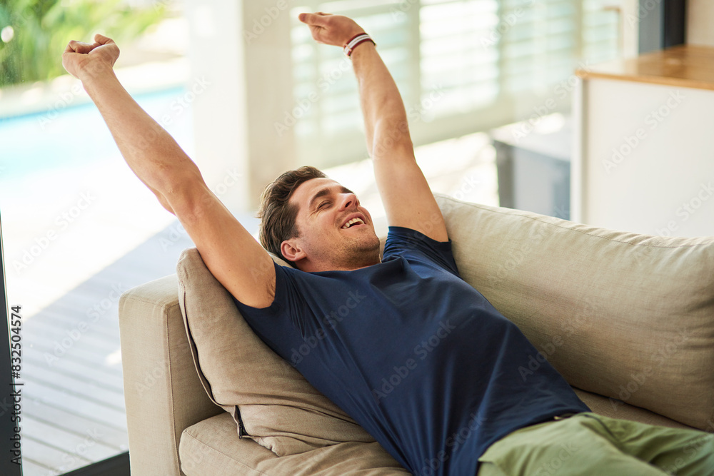 Stretching, relax and happy man on sofa in home for peace, calm or rest in living room in morning for health. Comfort, energy and person on couch for nap, sleeping and wake up in apartment on holiday Stretching, relax and happy man on sofa in home for peace, calm or rest in living room in morning for health. Comfort, energy and person on couch for nap, sleeping and wake up in apartment on holiday