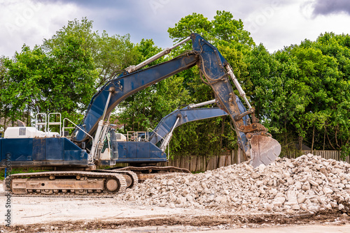Wall Mural demolition comapany mechanical shovels on a job site with rubble remains of buil