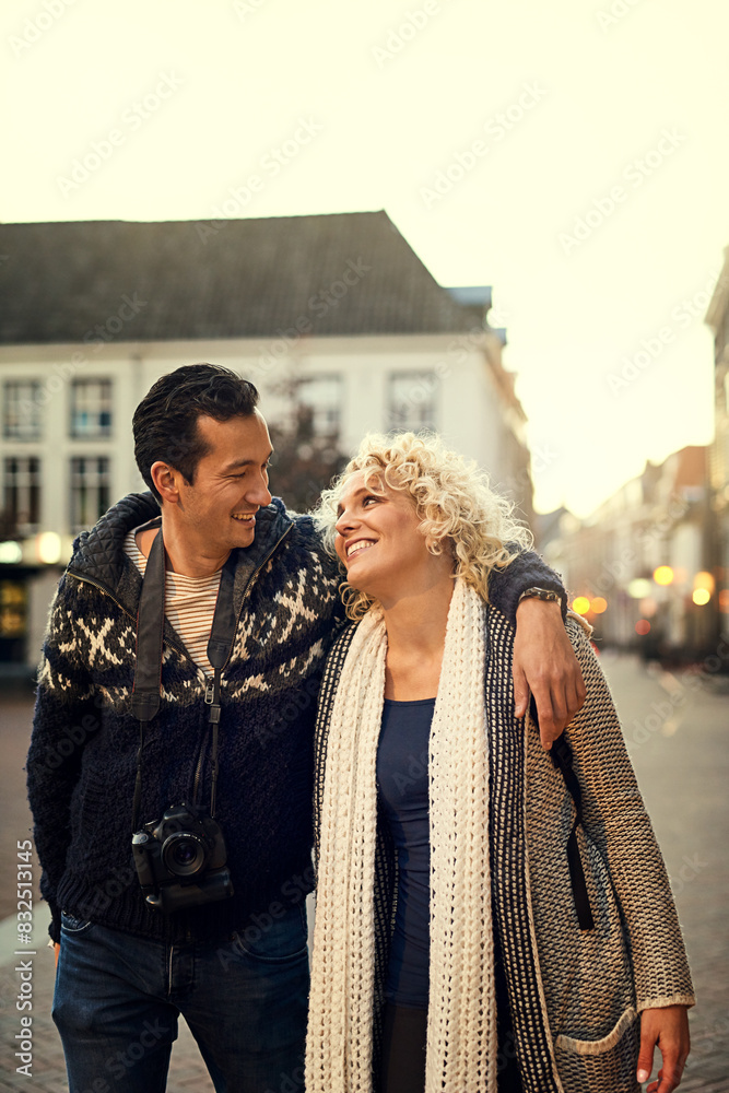 Obraz premium Couple, winter and love in city for vacation, travel and hug on holiday with smile in street. Man, woman and partnership for journey, relationship and adventure together in London with happiness