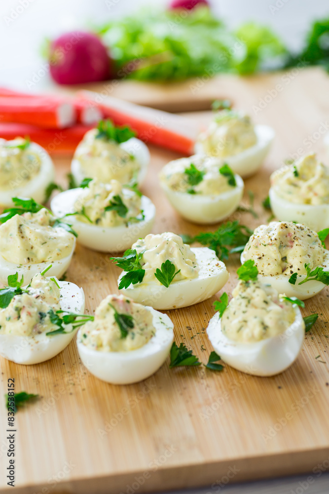 stuffed eggs, deviled eggs on a wooden table stuffed eggs, deviled eggs on a wooden table