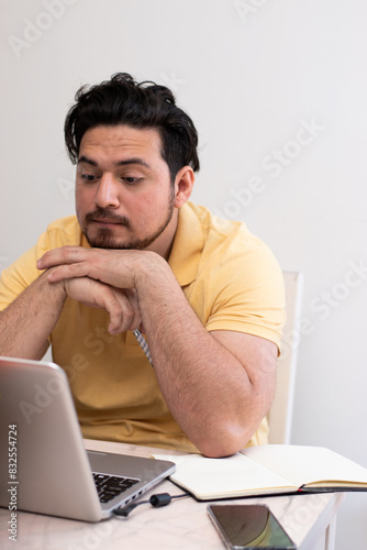 Student making reflection gesture front his laptop in virtual class