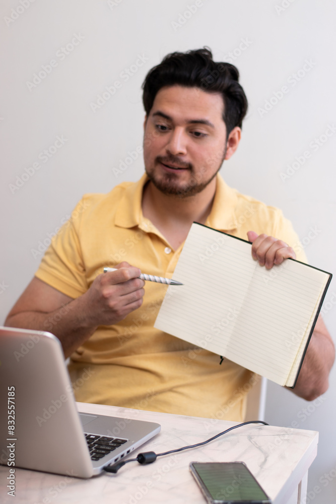Young adult teaching to the virtual class the exercise in his book Young adult teaching to the virtual class the exercise in his book