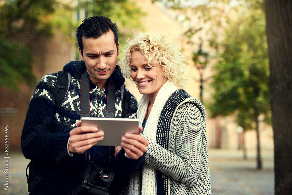 City travel, couple and tablet with internet for social media, urban adventure and research for international holiday. Man, woman and digital tech with online blog and vacation together in Berlin City travel, couple and tablet with internet for social media, urban adventure and research for international holiday. Man, woman and digital tech with online blog and vacation together in Berlin