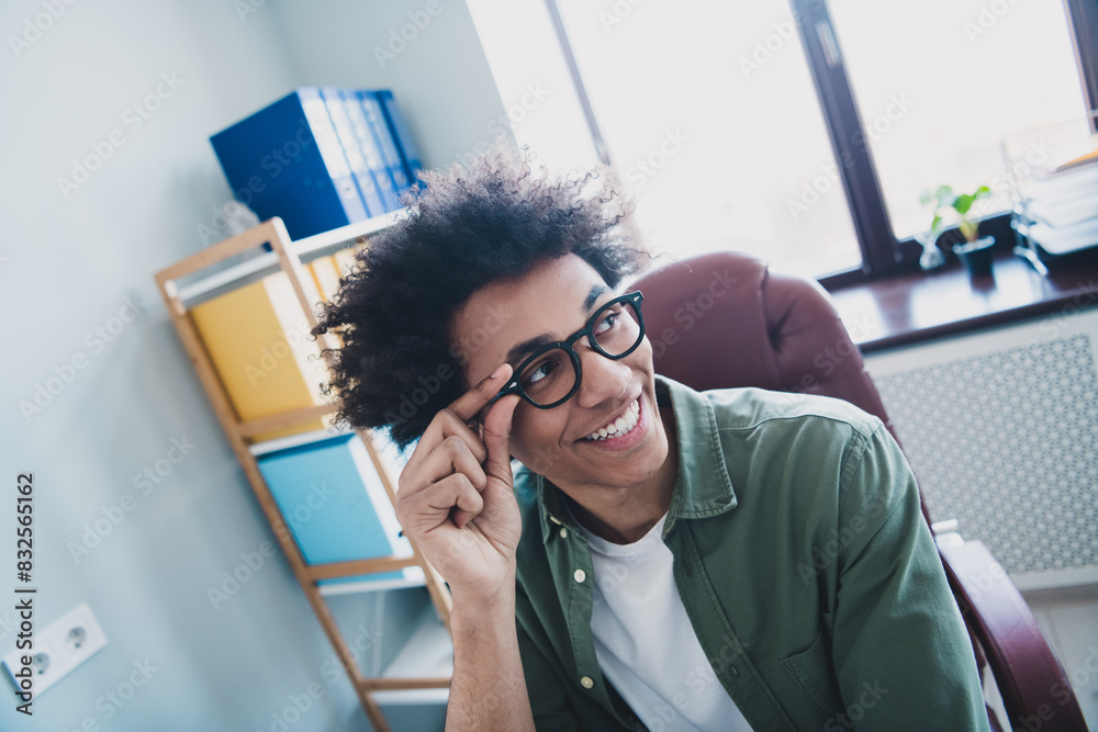 Fototapeta premium Photo of happy positive broker wear khaki shirt arm hand spectacles smiling indoors workshop workstation